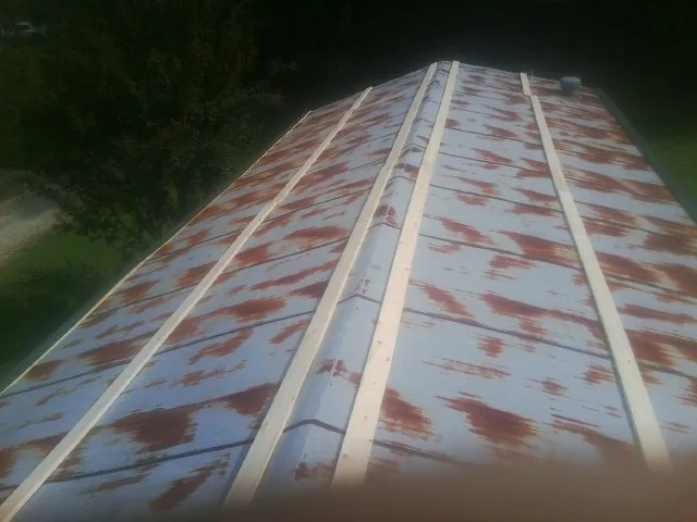Rusted metal roof panels with new wood purlins before replacement — Storm Damage Roof Repair in Lithopolis by Roofing Brothers