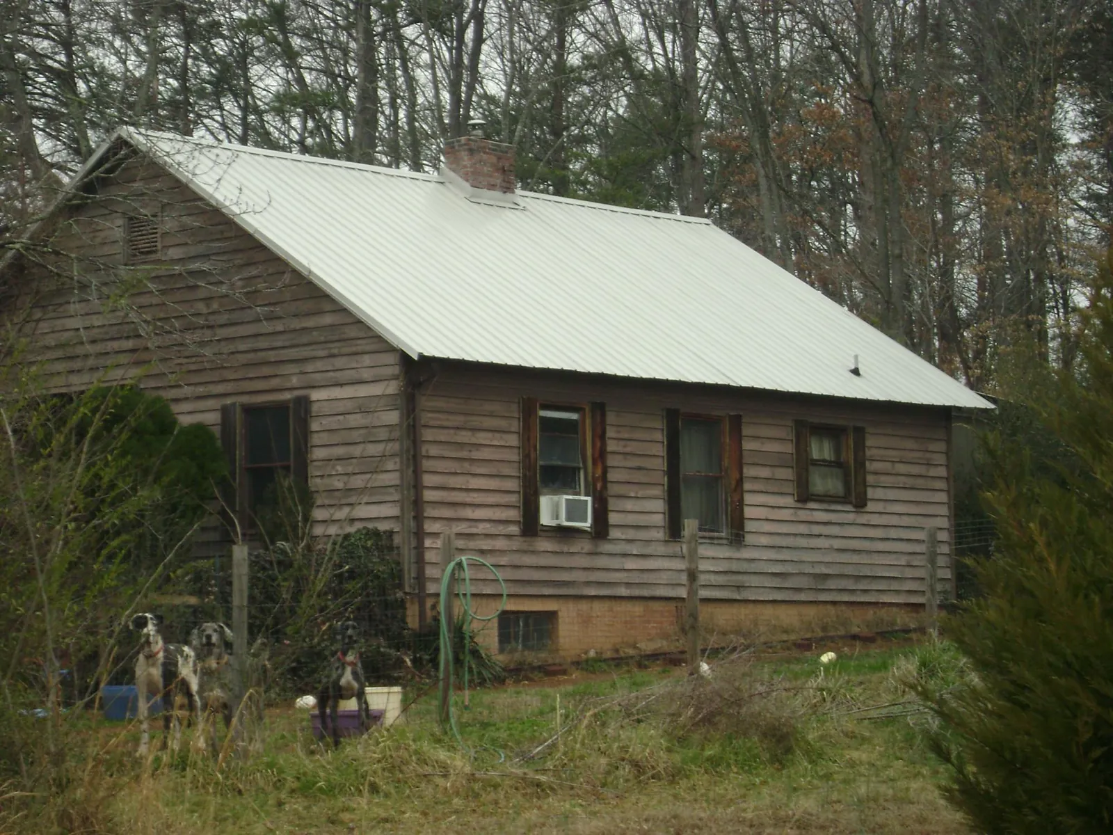 White metal roof on an old wood sided farmhouse, from a Metal Roof Installation job in Lithopolis